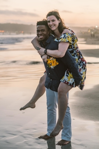 engagement session coronado island sunset san diego california white girl yellow flowers blue red dress african american interracial couple dusk