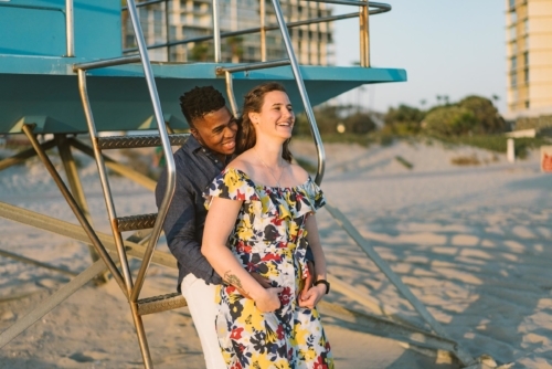 engagement session coronado lifeguard tower island sunset san diego california white girl yellow blue red dress african american interracial couple dusk