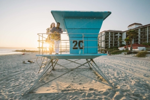 engagement session coronado lifeguard tower island sunset san diego california white girl yellow blue red dress african american interracial couple dusk