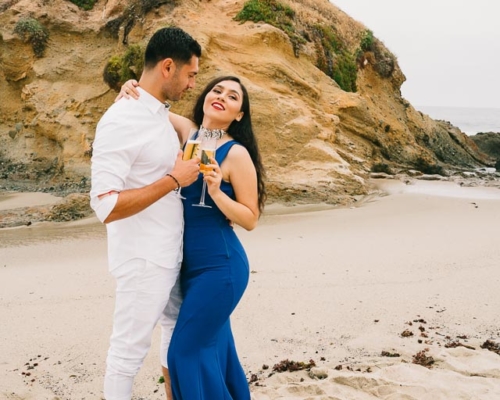 engagements portfolio orange county laguna beach victoria beach latino couple toasting champagne